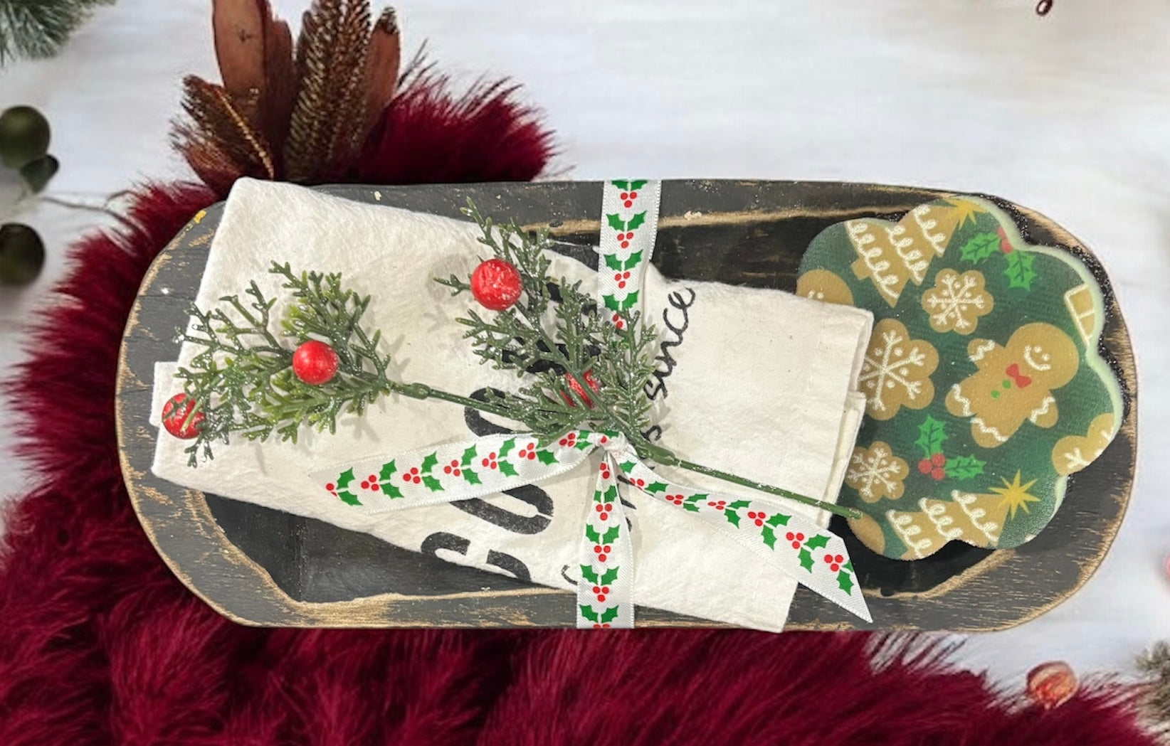 Decorative gift with Christmas-themed packaging on a red textured surface